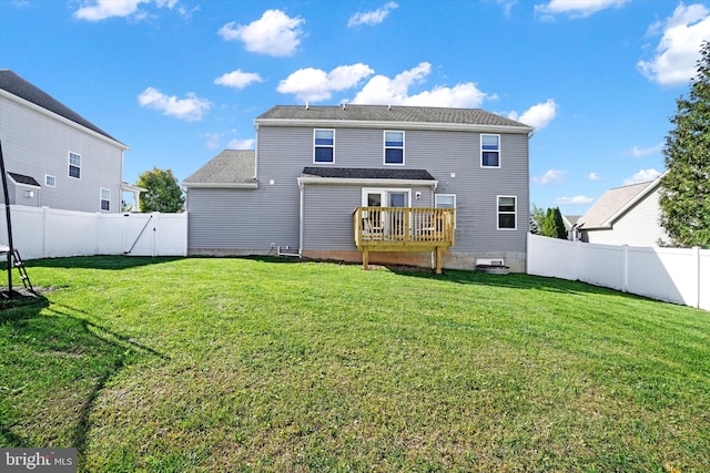 back of property featuring a yard and a wooden deck