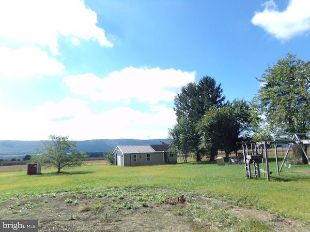 view of yard with a mountain view and a rural view