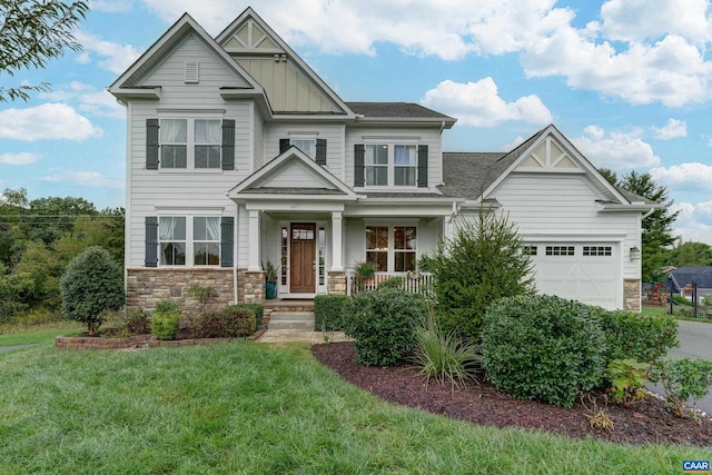 craftsman-style house with a garage, a front lawn, and covered porch