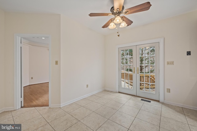 empty room featuring ceiling fan, light tile patterned flooring, and french doors