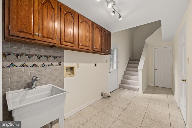 clothes washing area with hookup for an electric dryer, light tile patterned floors, cabinets, and washer hookup