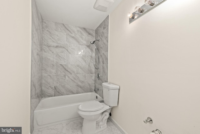 bathroom with tiled shower / bath combo and toilet