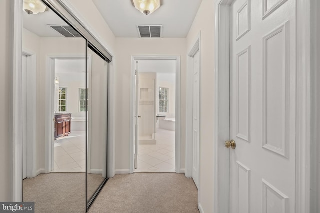 hallway with light colored carpet