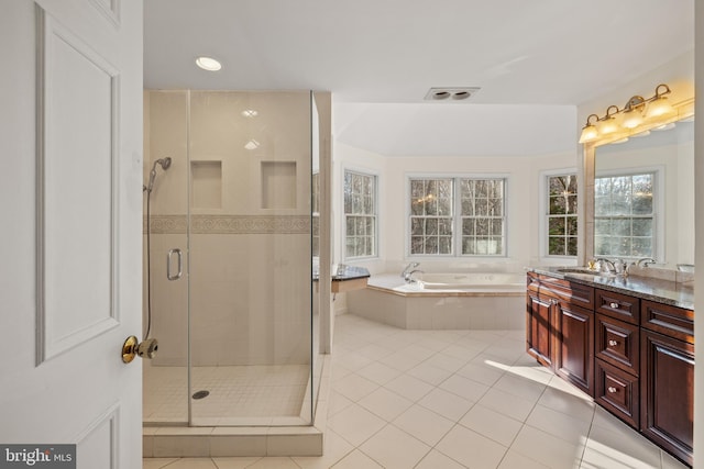 bathroom with tile patterned floors, vanity, and separate shower and tub