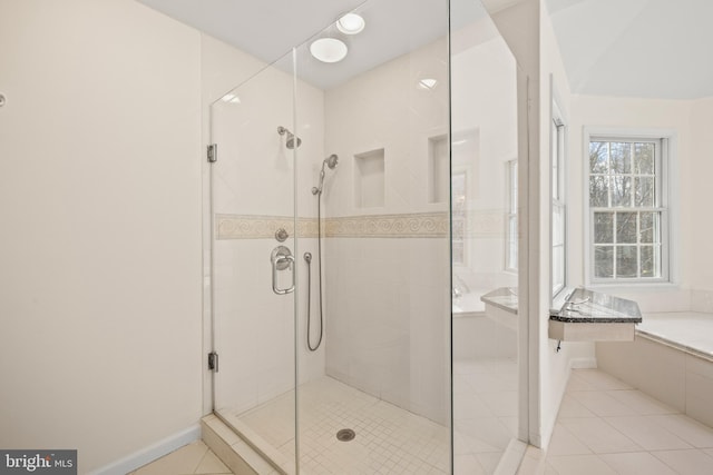 bathroom with tile patterned floors and an enclosed shower