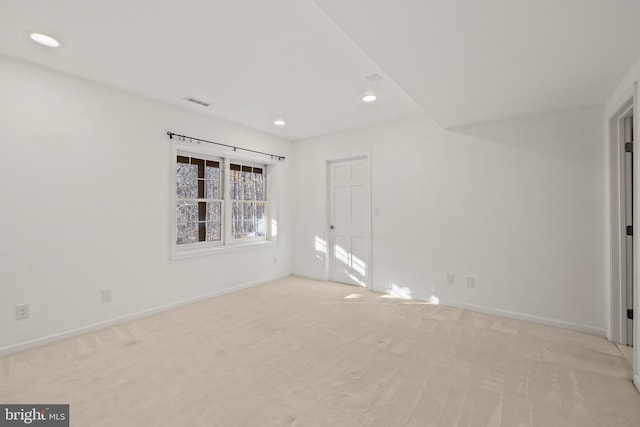 spare room with light colored carpet