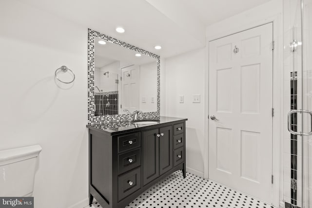 bathroom with vanity, toilet, and walk in shower