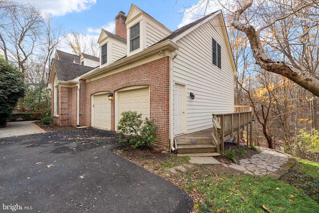 view of side of home featuring a garage