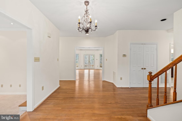 interior space featuring light hardwood / wood-style flooring and a notable chandelier