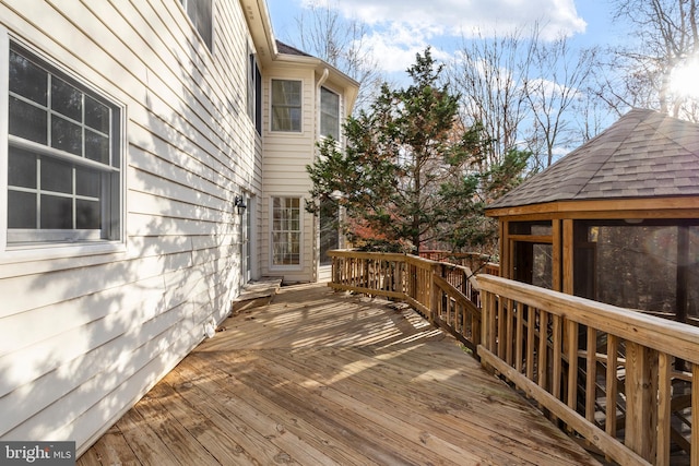 wooden terrace featuring a gazebo