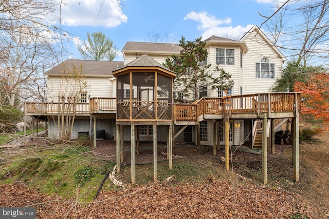 rear view of house with a sunroom, central air condition unit, and a wooden deck