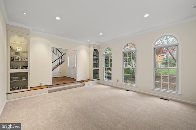 carpeted empty room with ornamental molding