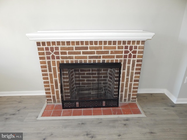 room details with a fireplace and hardwood / wood-style floors