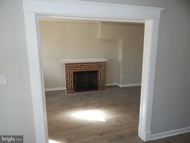 room details with a brick fireplace and hardwood / wood-style flooring