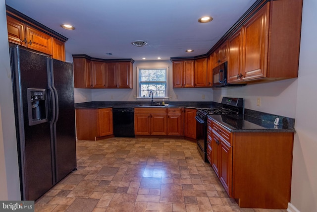 kitchen featuring recessed lighting, brown cabinets, a sink, and black appliances