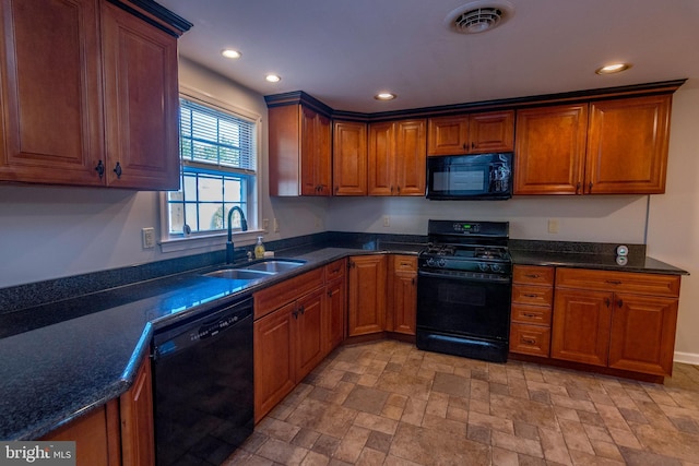 kitchen featuring recessed lighting, black appliances, visible vents, brown cabinets, and a sink