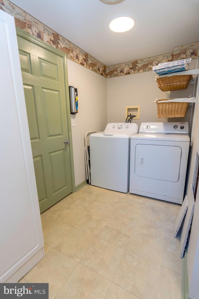 washroom featuring washing machine and clothes dryer and light tile patterned floors