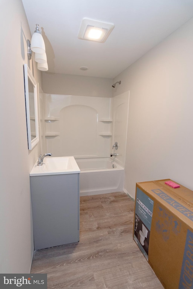 full bathroom featuring shower / bath combination, wood finished floors, and vanity