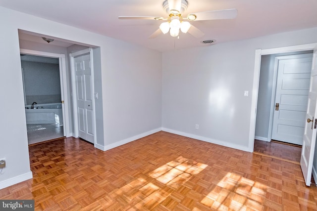 spare room with visible vents, baseboards, and a ceiling fan
