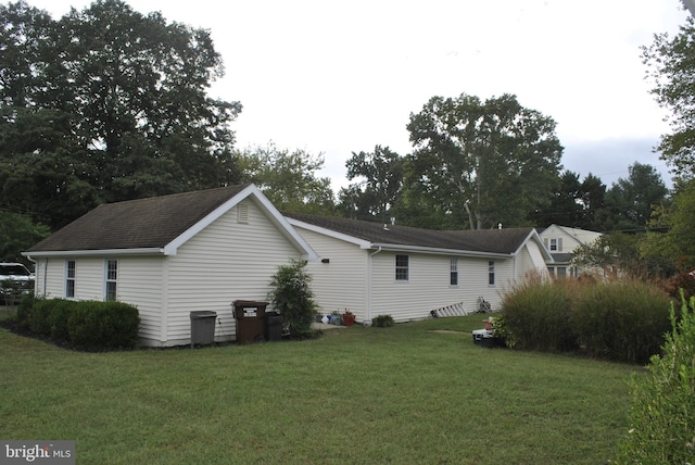 view of property exterior with a yard