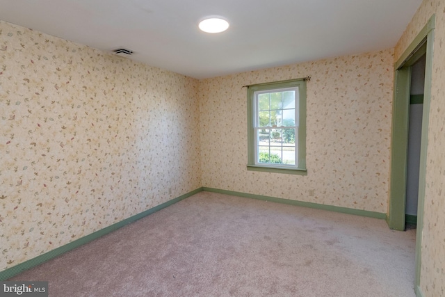 spare room with carpet flooring and visible vents