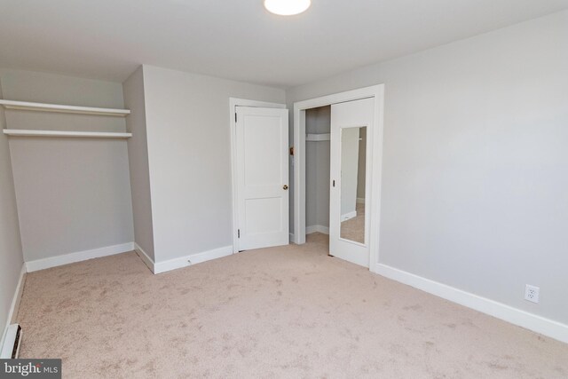 unfurnished bedroom with carpet flooring and baseboards