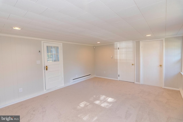 carpeted empty room featuring a baseboard heating unit, baseboards, ornamental molding, and recessed lighting