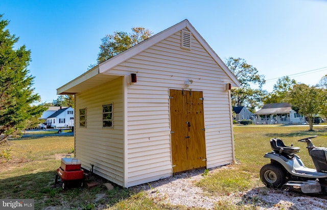 view of outbuilding with a lawn