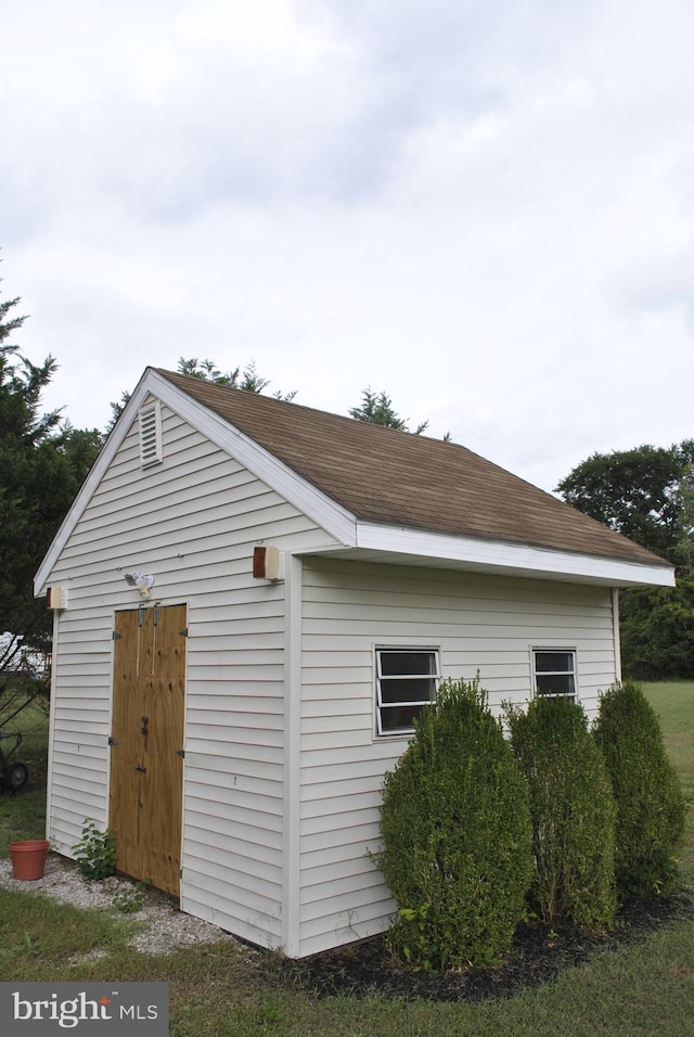 view of side of property with an outbuilding