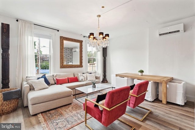 living room featuring hardwood / wood-style flooring, plenty of natural light, a wall mounted air conditioner, and a chandelier