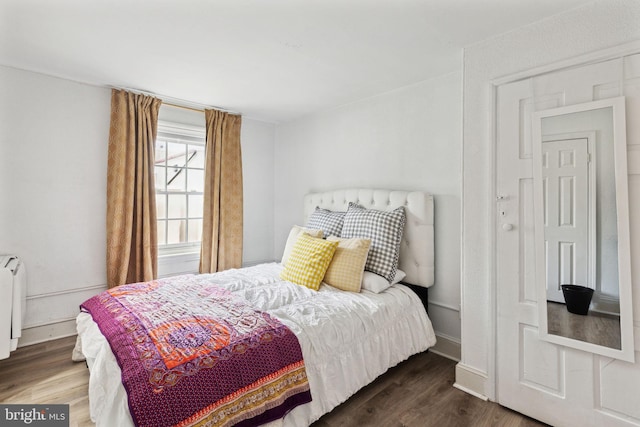 bedroom featuring dark hardwood / wood-style flooring