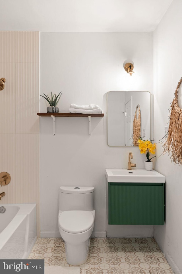 bathroom with tile patterned flooring, a bathtub, vanity, and toilet