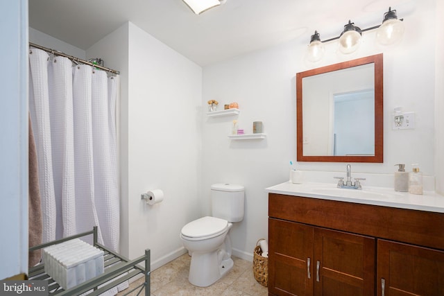 bathroom with vanity, toilet, and tile patterned floors