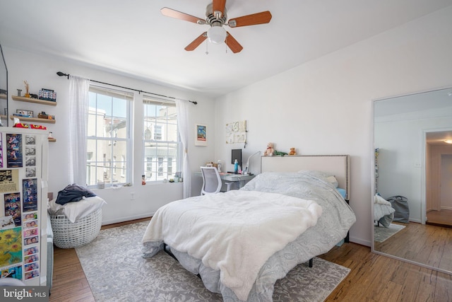 bedroom featuring ceiling fan and hardwood / wood-style flooring