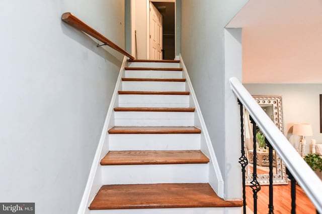 stairs with hardwood / wood-style floors