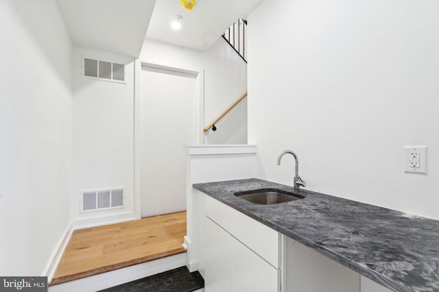 bathroom with hardwood / wood-style flooring and vanity