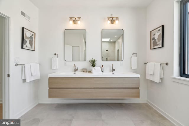 bathroom with walk in shower and vanity