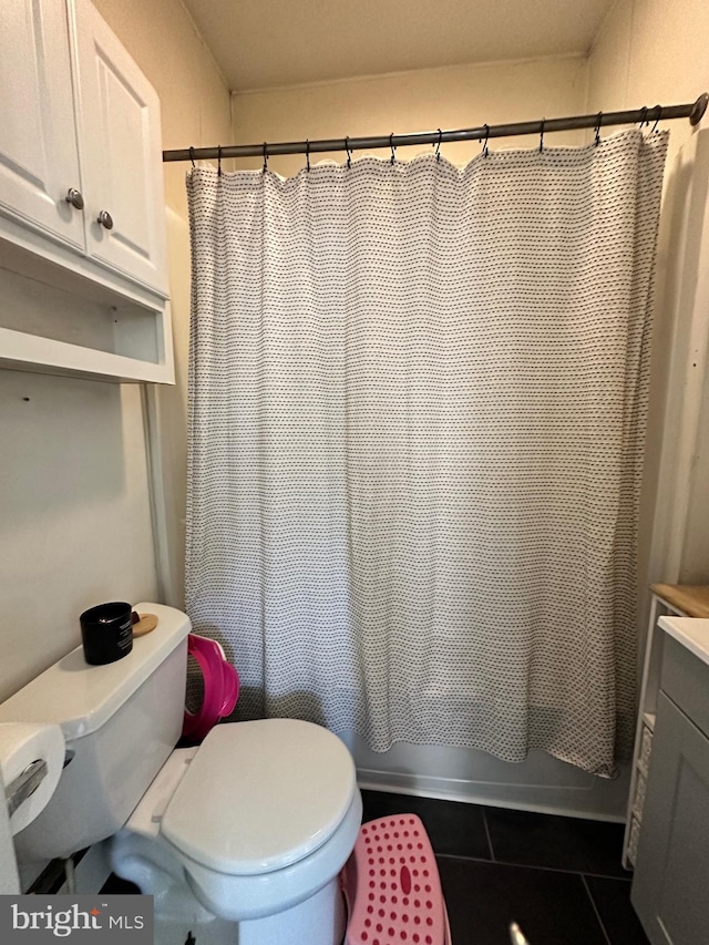 full bathroom with vanity, toilet, shower / bath combo with shower curtain, and tile patterned floors