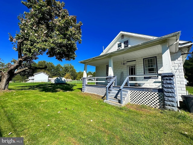 bungalow featuring a porch and a front lawn