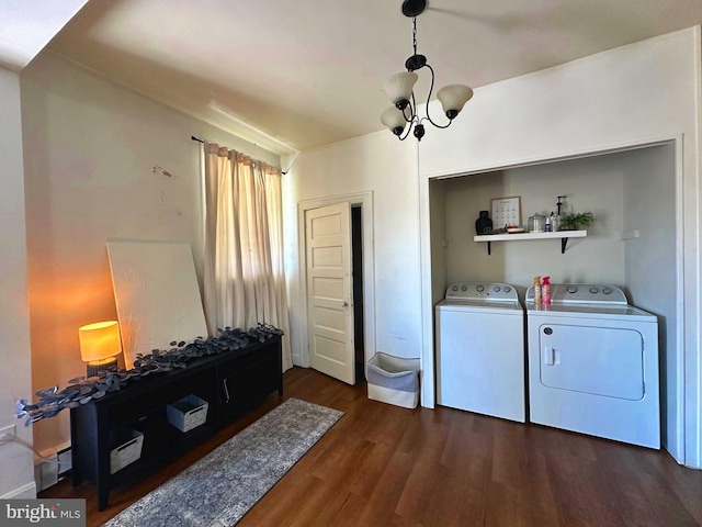 laundry room featuring a notable chandelier, dark hardwood / wood-style floors, and washer and clothes dryer