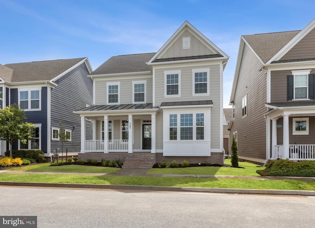 craftsman inspired home featuring a front yard and covered porch