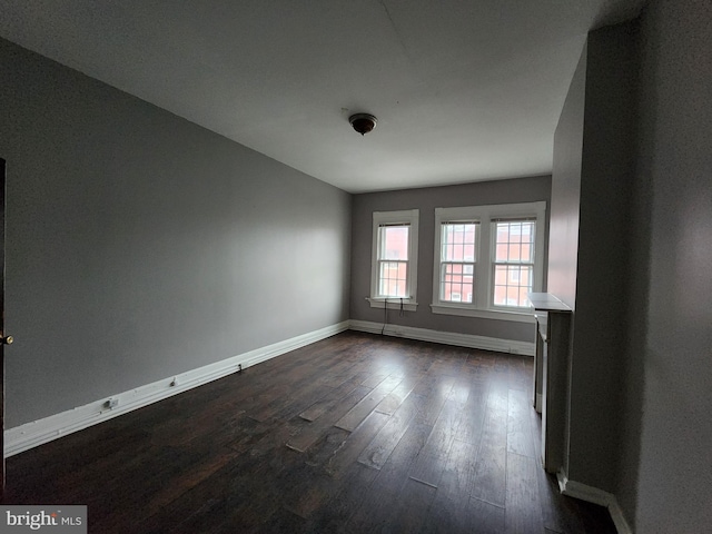 empty room featuring dark hardwood / wood-style flooring