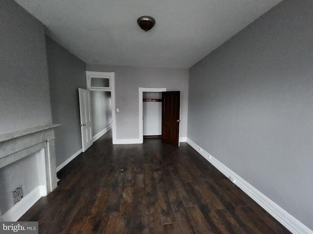 unfurnished living room featuring dark hardwood / wood-style floors