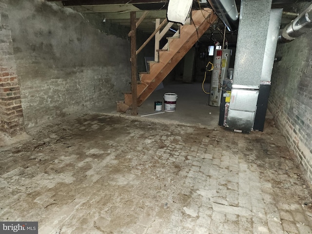 basement featuring gas water heater and heating unit