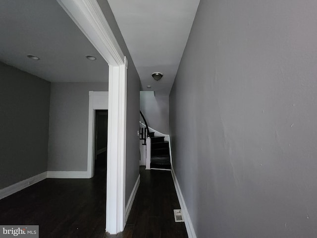 hallway featuring dark hardwood / wood-style flooring