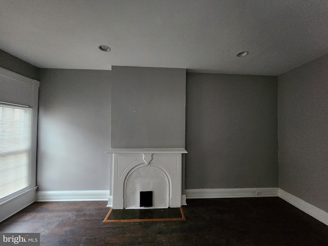 unfurnished living room featuring dark hardwood / wood-style flooring