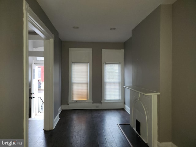 unfurnished living room with dark hardwood / wood-style floors