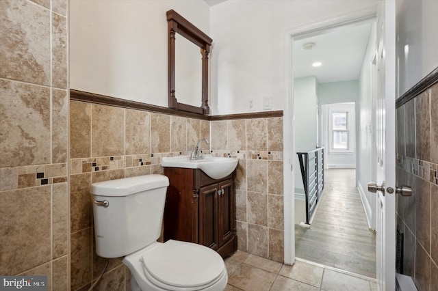 bathroom with vanity, tile walls, hardwood / wood-style floors, and toilet