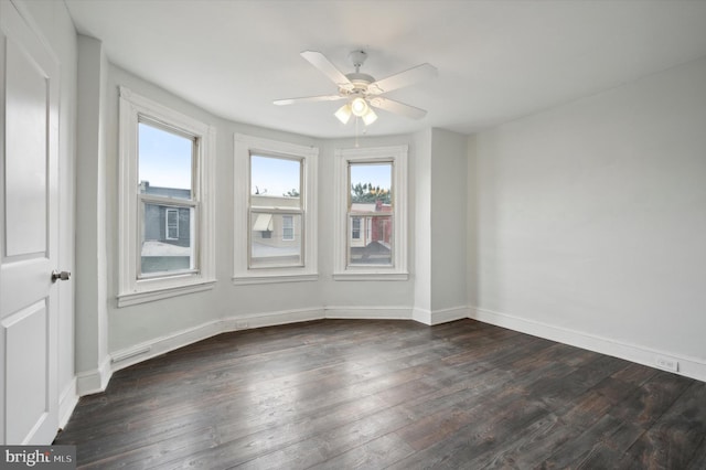 unfurnished room featuring ceiling fan and dark wood-type flooring