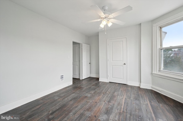 unfurnished bedroom featuring dark hardwood / wood-style flooring and ceiling fan